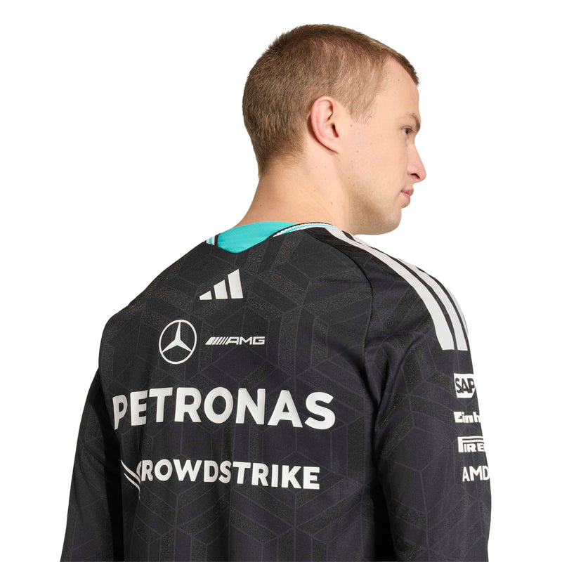 adidas man shown from the back wearing a black Mercedes-AMG Petronas F1 team jersey with white sponsor logos and white stripes on the shoulders, against a plain white background.