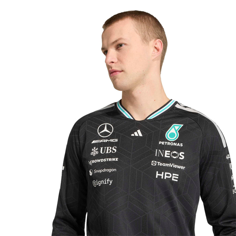 adidas man wearing a black Mercedes Petronas Formula 1 team jersey with various sponsor logos, photographed against a solid white background.