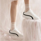 SneakSurf Racer in Cream White/Black worn on foot, full styling view