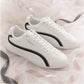 SneakSurf Racer in Cream White/Black styled pair on fabric