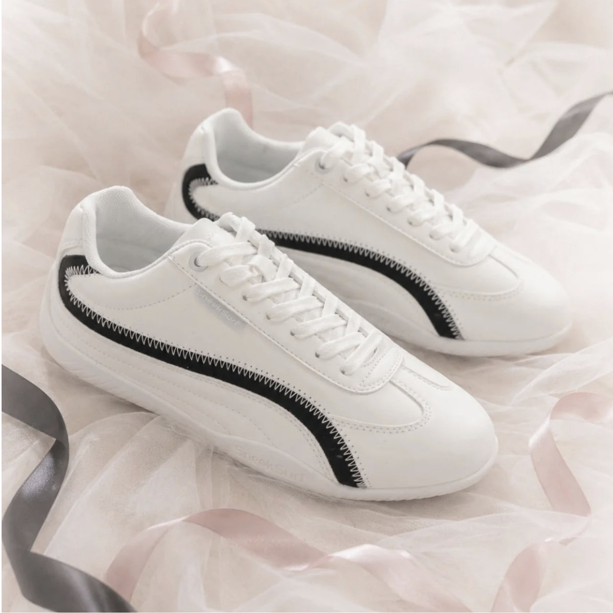SneakSurf Racer in Cream White/Black styled pair on fabric