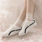 SneakSurf Racer in Cream White/Black worn on foot, close-up styling